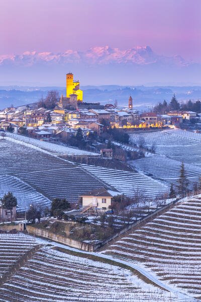 Blue hour on the medieval town of Serralunga d'Alba and its castle viewed from the surrounding vineyards. Serralunga d'Alba, Langhe, Piedmont, Italy, Europe.