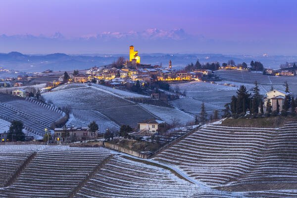 Blue hour on the medieval town of Serralunga d'Alba and its castle viewed from the surrounding vineyards. Serralunga d'Alba, Langhe, Piedmont, Italy, Europe.