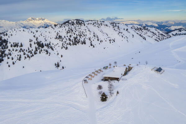 Aerial view of the Parafulmine refuge, Monte Farno and the Presolana massif in the back covered in snow. Monte Farno, Gandino, Valgandino, Val Seriana, Bergamo province, Lombardy, Italy.