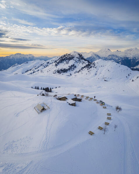 Aerial view of the Parafulmine refuge, Monte Farno and Pizzo Formico in winter at sunset. Monte Farno, Gandino, Valgandino, Val Seriana, Bergamo province, Lombardy, Italy.