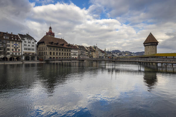 View of the Kapellbrücke bridge and the Wasserturm at sunset reflected on the Reuss river. Lucerne, canton of Lucerne, Switzerland.