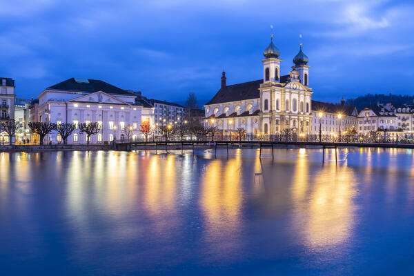 View of the Jesuit Church and the old town of Lucerne at blue hour reflected on the Reuss river. Lucerne, canton of Lucerne, Switzerland.