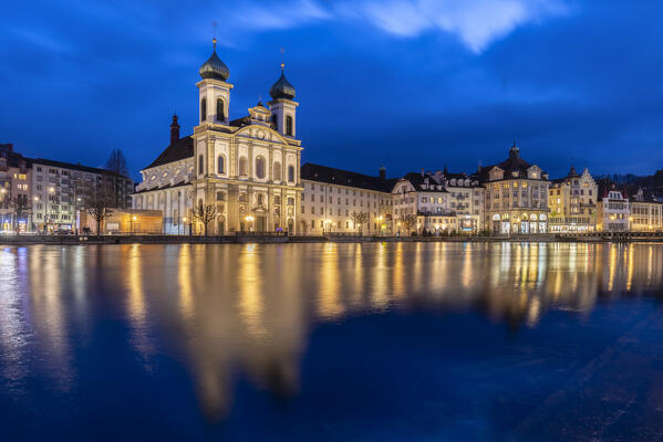 View of the Jesuit Church and the old town of Lucerne at blue hour reflected on the Reuss river. Lucerne, canton of Lucerne, Switzerland.