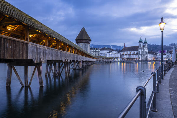 View of the Kapellbrücke bridge, the Jesuit Church and the  Wasserturm reflected on the Reuss river. Lucerne, canton of Lucerne, Switzerland.