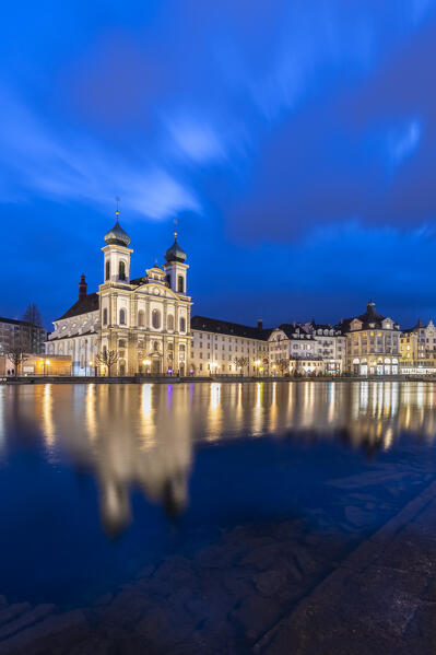 View of the Jesuit Church and the old town of Lucerne at blue hour reflected on the Reuss river. Lucerne, canton of Lucerne, Switzerland.