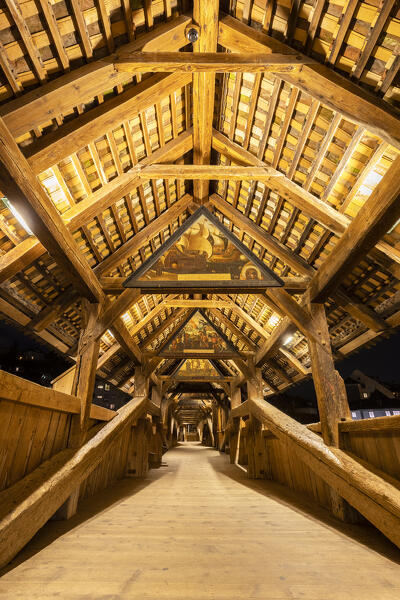 View of the wooden footbridge of Spreuerbrücke at night with the paintings of the Totentanz cycle by Kaspar Meglinger. Lucerne, canton of Lucerne, Switzerland.