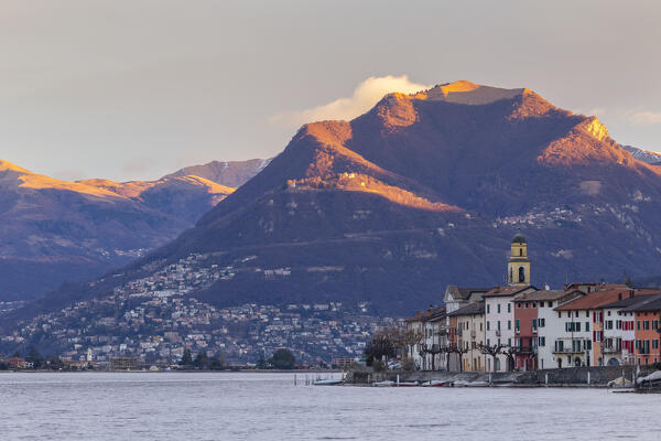Sunrise in Brusino Arsizio and Lugano in the distance, Lake Ceresio, Canton Ticino, Switzerland.