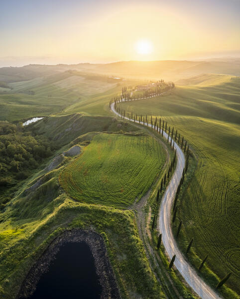 Aerial view of the farmhouse Baccoleno at sunset. Asciano, Siena province, Tuscany, Italy. 