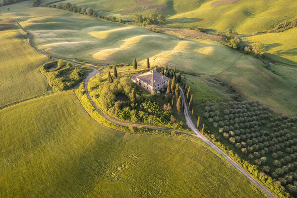 Aerial view of the famous Podere Belvedere and the surrounding countryside at sunrise. San Quirico d'Orcia, Val d'Orcia, Tuscany, Italy.
