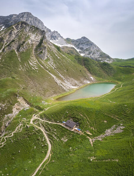 Aerial view of the Branchino lake and Rifugio Branchino during spring time. Valcanale, Ardesio, Val Seriana, Bergamo district, Lombardy, Italy, Southern Europe.
