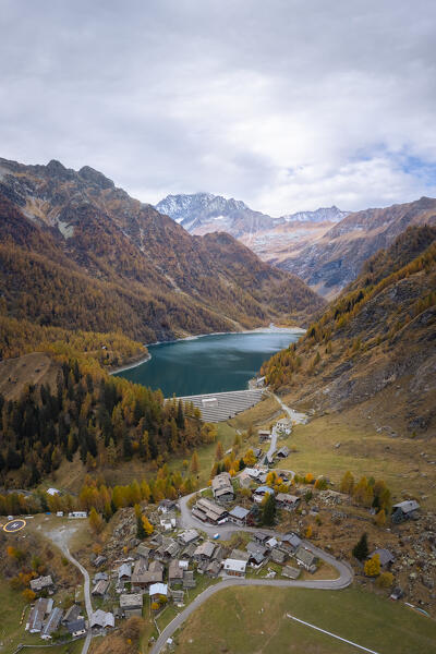 View of the small town of Cheggio and Lago dei Cavalli with Pizzo d'Andolla. Alpe Cheggio, Antrona Valley, Piedmont, Verbano Cusio Ossola, Italy.