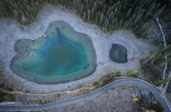 Aerial view of the Karersee lake in autumn at sunrise. Carezza, Dolomites, South Tyrol, Trentino Alto Adige, Italy. 