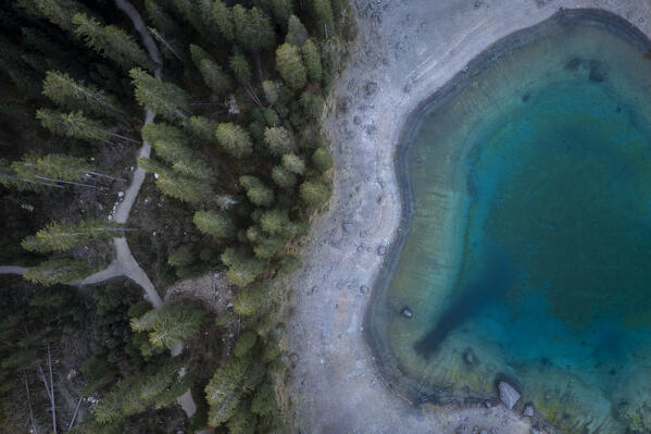Aerial view of the Karersee lake in autumn at sunrise. Carezza, Dolomites, South Tyrol, Trentino Alto Adige, Italy. 