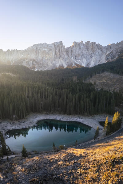 Aerial view of the Karersee lake in autumn at sunrise. Carezza, Dolomites, South Tyrol, Trentino Alto Adige, Italy. 