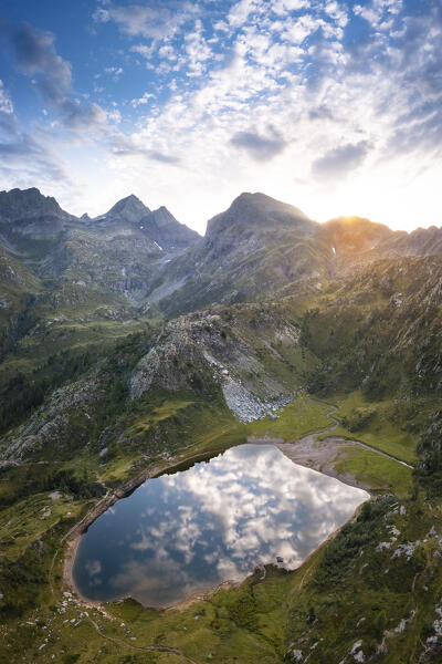 View of the Rifugio Calvi and Lake Rotondo during a summer sunrise. Carona, Val Brembana, Alpi Orobie, Bergamo, Bergamo Province, Lombardy, Italy, Europe.