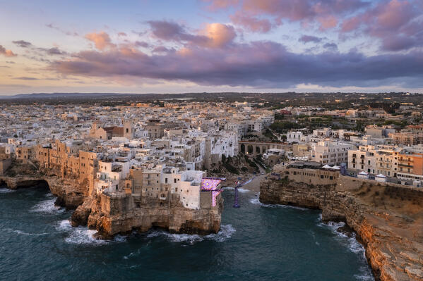 Aerial view of the overhanging houses of Polignano a Mare at sunrise. Bari district, Apulia, Italy, Europe.