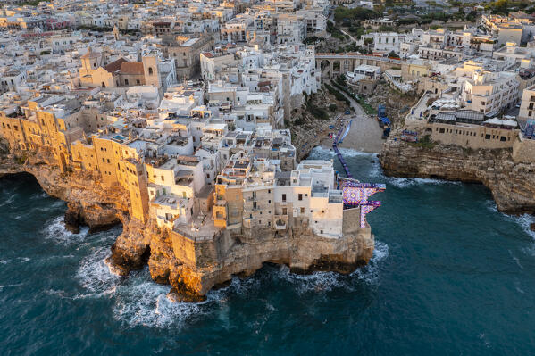 Aerial view of the overhanging houses of Polignano a Mare at sunrise. Bari district, Apulia, Italy, Europe.