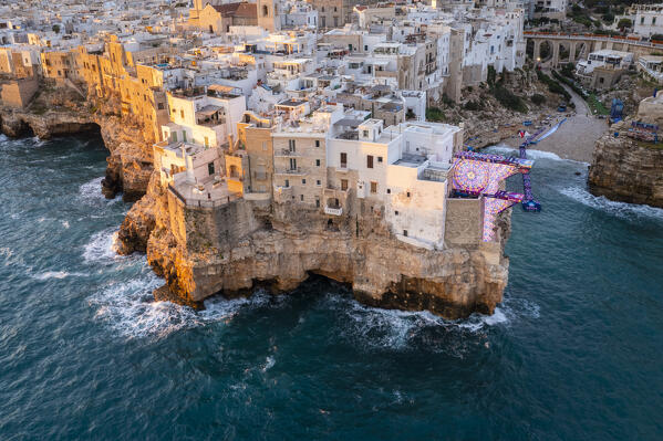 Aerial view of the overhanging houses of Polignano a Mare at sunrise. Bari district, Apulia, Italy, Europe.