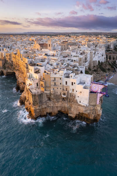 Aerial view of the overhanging houses of Polignano a Mare at sunrise. Bari district, Apulia, Italy, Europe.
