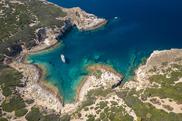 View of a boat at Cala dei Turchi on Isola di Capraia. Tremiti Islands, Foggia district, Puglia, Italy.