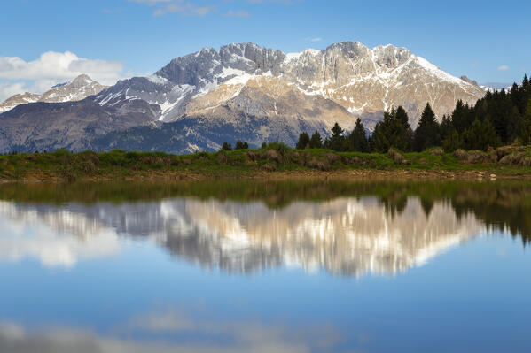 View of the Presolana mountain reflected on a spring pond on Monte Pora. Songavazzo, Val Seriana, Bergamo district, Lombardy, Italy, Southern Europe.