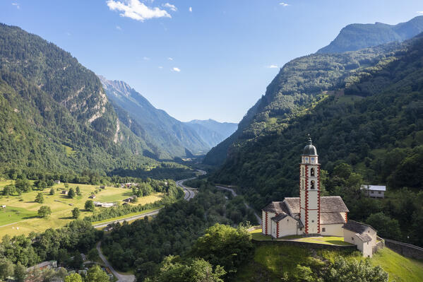 Aerial view of the San martino church of Soazza dominating the road to San Bernardino pass. Graubünden, Moesa district, Switzerland, Europe.