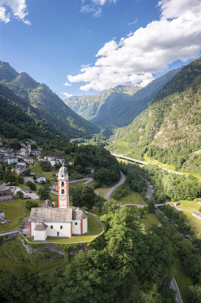 Aerial view of the San martino church of Soazza dominating the road to San Bernardino pass. Graubünden, Moesa district, Switzerland, Europe.