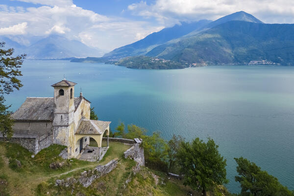 Aerial view of the church of Sant'Eufemia in Musso overlooking Lake Como. Musso, Como district, Lake Como, Lombardy, Italy