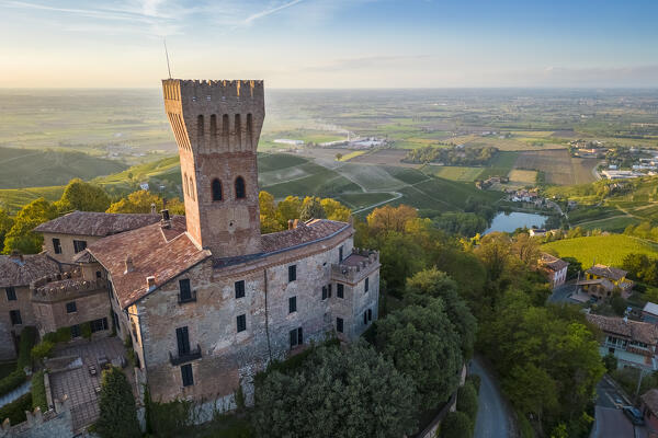 Aerial view of a summer sunset over the Cigognola castle. Cigognola, Oltrepo Pavese, Pavia district, Lombardy, Italy.