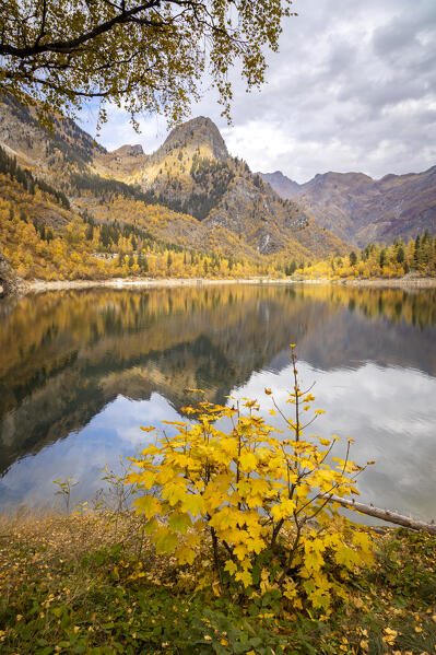 View of Lago di Antrona in autumn colors from the trail around the lake, Valle Antrona, Piedmont, Italy.