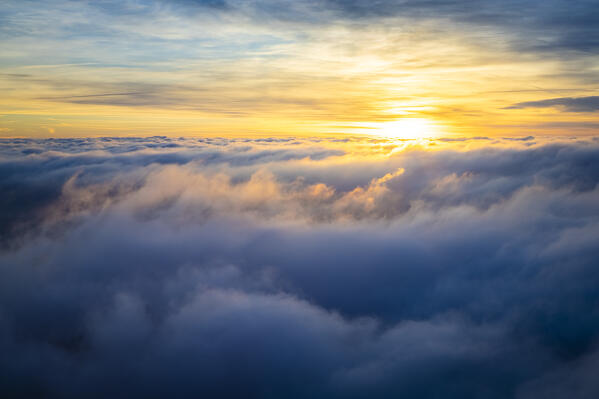 Sunrise view of a sea of clouds over the town of Santa Maria del Monte in winter from the Campo dei Fiori. Campo dei Fiori, Varese, Parco Campo dei Fiori, Lombardy, Italy.