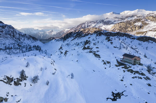 View of the Rifugio Calvi and Fregabolgia lake at sunset in winter. Carona, Val Brembana, Alpi Orobie, Bergamo, Bergamo Province, Lombardy, Italy, Europe.