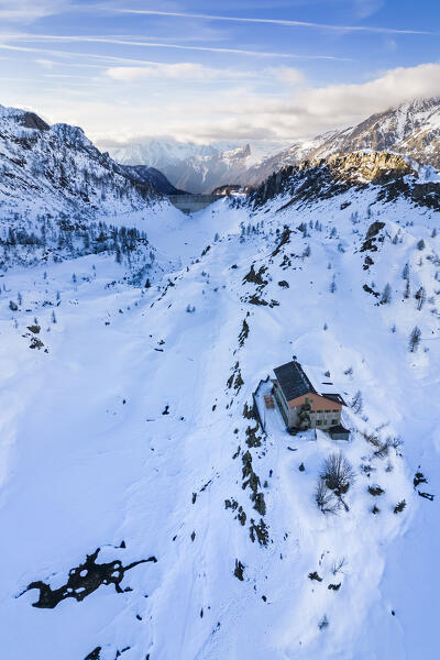 View of the Rifugio Calvi and Fregabolgia lake at sunset in winter. Carona, Val Brembana, Alpi Orobie, Bergamo, Bergamo Province, Lombardy, Italy, Europe.