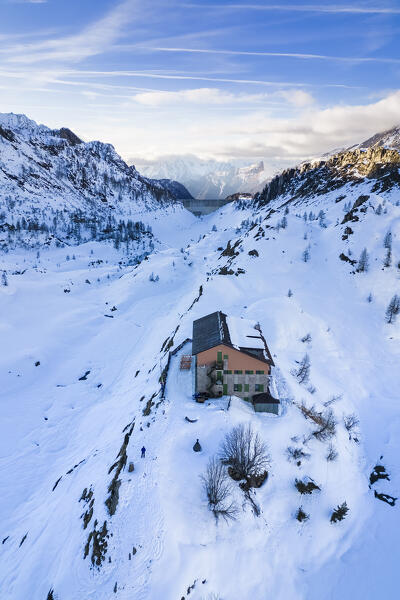 View of the Rifugio Calvi and Fregabolgia lake at sunset in winter. Carona, Val Brembana, Alpi Orobie, Bergamo, Bergamo Province, Lombardy, Italy, Europe.