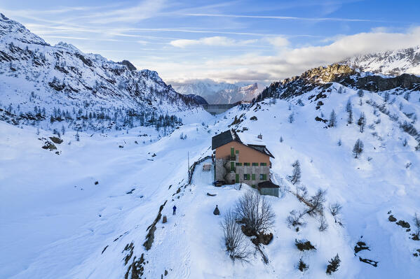 View of the Rifugio Calvi and Fregabolgia lake at sunset in winter. Carona, Val Brembana, Alpi Orobie, Bergamo, Bergamo Province, Lombardy, Italy, Europe.