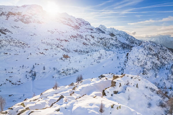 View of the Rifugio Calvi and Rotondo lake at sunset in winter. Carona, Val Brembana, Alpi Orobie, Bergamo, Bergamo Province, Lombardy, Italy, Europe.