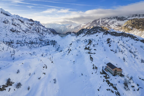 View of the Rifugio Calvi and Fregabolgia lake at sunset in winter. Carona, Val Brembana, Alpi Orobie, Bergamo, Bergamo Province, Lombardy, Italy, Europe.