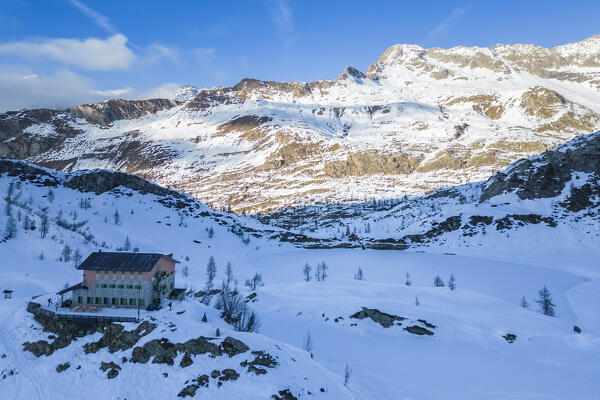 View of the Rifugio Calvi and Rotondo lake at sunset in winter. Carona, Val Brembana, Alpi Orobie, Bergamo, Bergamo Province, Lombardy, Italy, Europe.