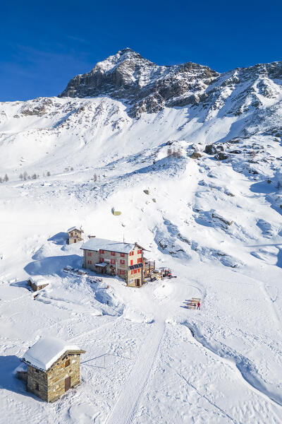 Rifugio Cristina and Pizzo Scalino in winter. Lanzada, Valmalenco, Valtellina, Sondrio district, Lombardy, Italy, Europe.