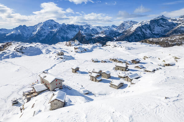 Alpe Prabello and Rifugio Cristina in winter with Mount Disgrazia in the background. Lanzada, Valmalenco, Valtellina, Sondrio district, Lombardy, Italy, Europe.