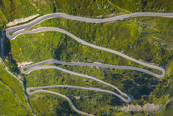 Aerial view of the Grimselstrasse leading to the top of Grimselpass at sunrise. Obergoms, Canton of Valais, Swiss Alps, Switzerland.