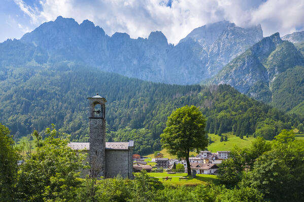 Aerial view of the small church called Cesulì in Colere town with view of the north face of the Presolana mountain in summer. Colere, Val di Scalve, Bergamo district, Lombardy, Italy, Southern Europe.