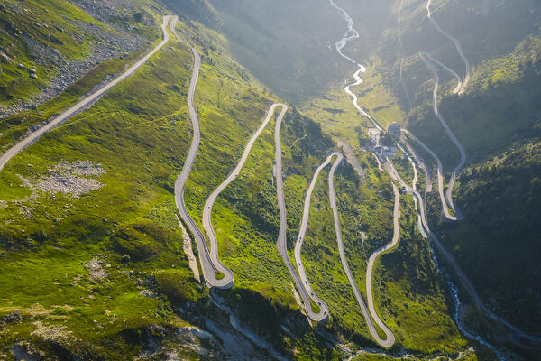 Aerial view of the Grimselstrasse leading to the top of Grimselpass at sunrise. Obergoms, Canton of Valais, Swiss Alps, Switzerland.
