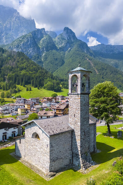 Aerial view of the small church called Cesulì in Colere town with view of the north face of the Presolana mountain in summer. Colere, Val di Scalve, Bergamo district, Lombardy, Italy, Southern Europe.