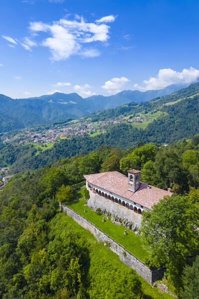 Aerial view of the Santissima Trinità di Parre church on a hill overlooking Valle Seriana. Val Seriana, Bergamo province, Lombardy, Italy.