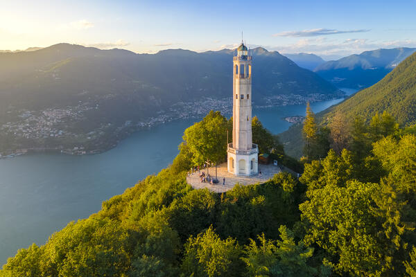 Aerial view of the Faro Voltiano (Volta Lighthouse) of Brunate overlooking Como and Como Lake in summer at sunset. Brunate, Province of Como, Lombardy, Italy, Europe.