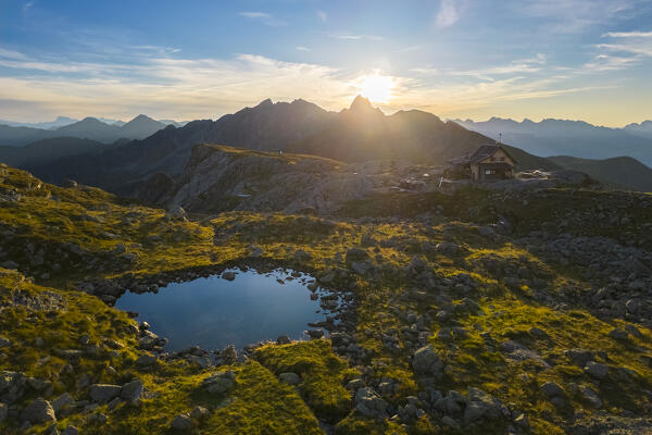 Aerial view of the Rifugio Benigni at sunrise. Ornica, Val Salmurano, Val Brembana, Alpi Orobie, Bergamo, Bergamo Province, Lombardy, Italy, Europe.