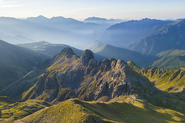 Aerial view of the crest below Rifugio Benigni at sunrise looking towards Ornica. Ornica, Val Salmurano, Val Brembana, Alpi Orobie, Bergamo, Bergamo Province, Lombardy, Italy, Europe.