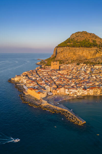 Aerial view of the ancient town of Cefalù, Unesco World Heritage site, at sunset. Palermo district, Sicily, Italy.