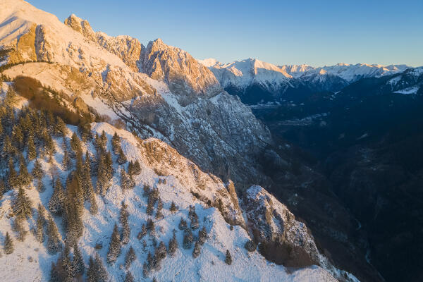 Aerial view of Monte Gulter and the Presolana massif after a winter snowfall at sunrise. Presolana pass, Castione della Presolana, Seriana Valley, Bergamo province, Lombardy, Italy.